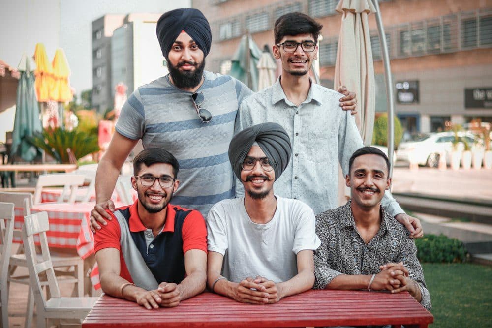 A group of young founders smiling outdoors